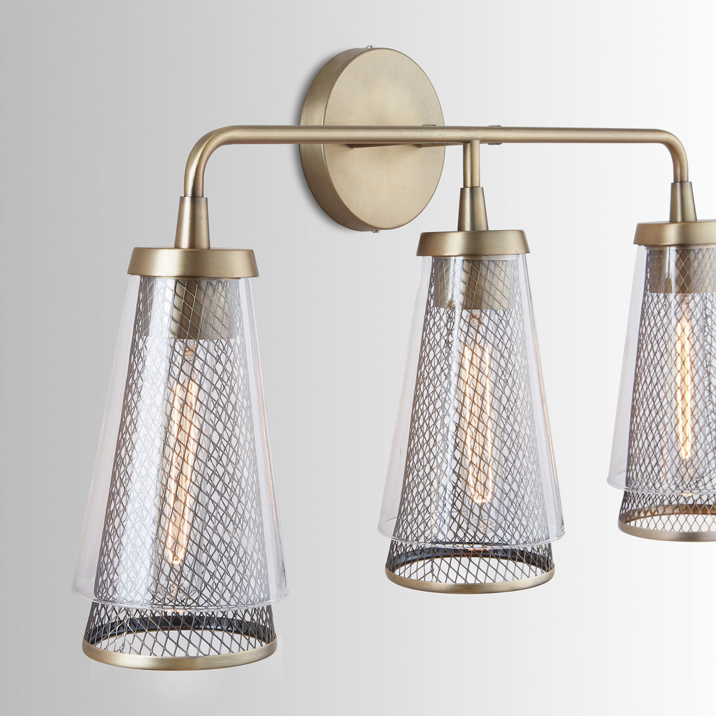 25" W x 14.5" H x 7" E 3-Light Vanity in Aged Brass with Mesh and Clear Glass Cone Shades