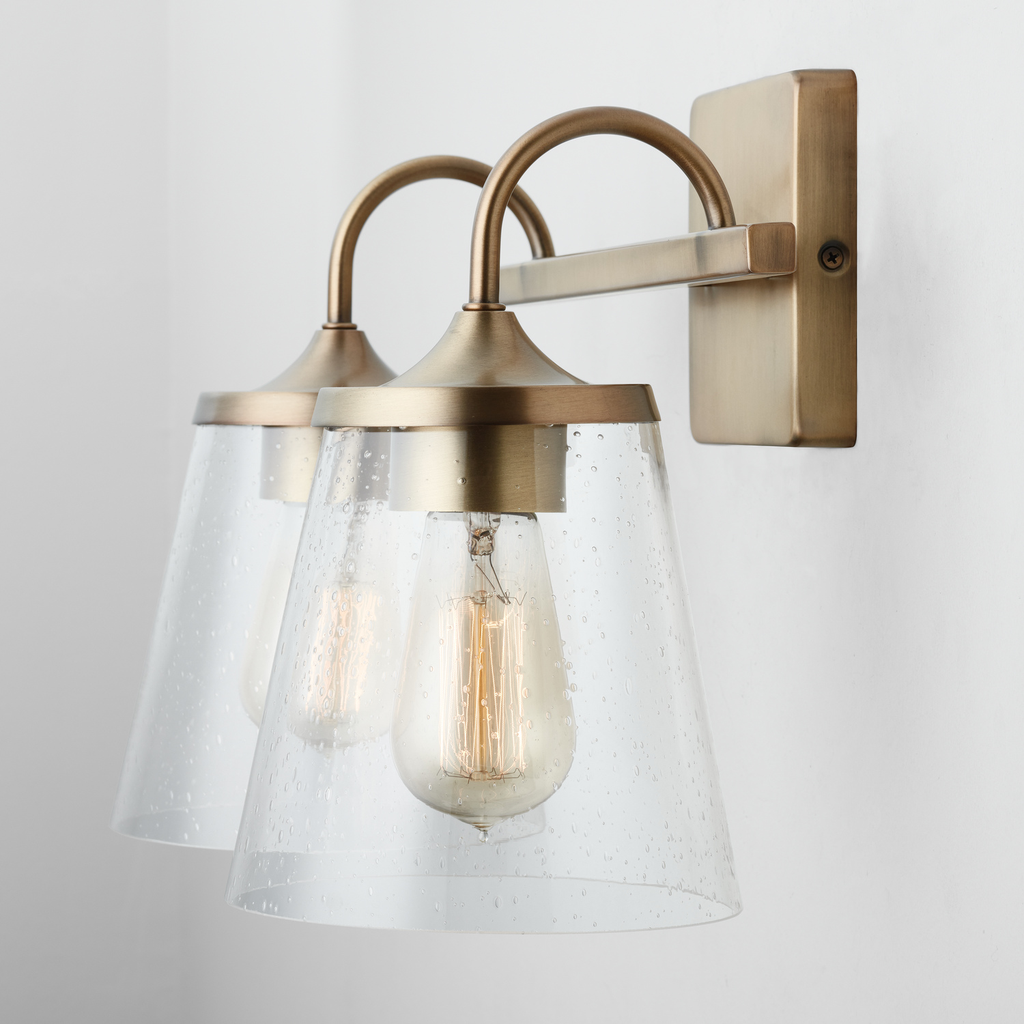 15" W x 10.5" H x 9" E 2-Light Vanity in Aged Brass with Clear Seeded Cone Glass Shades