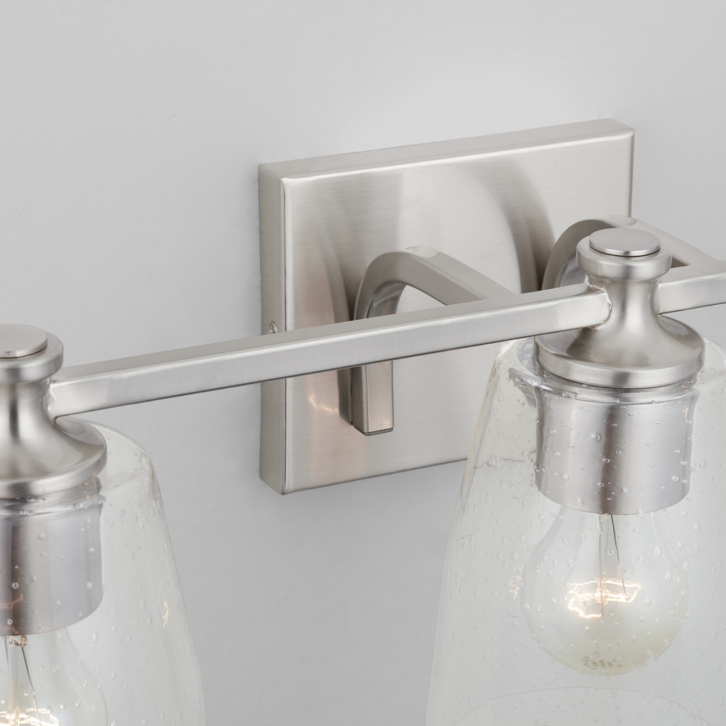 23" W x 8.5" H x 8" E 3-Light Clear Seeded Glass Vanity in Brushed Nickel