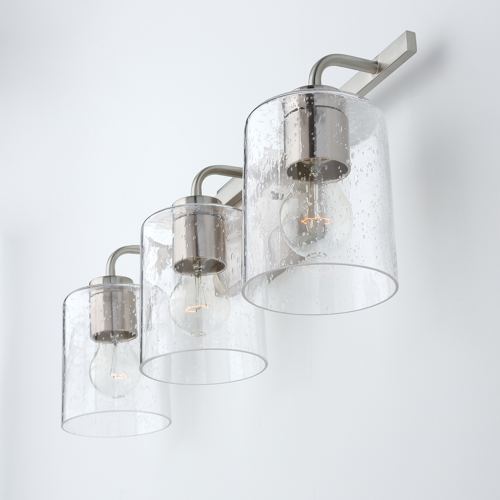 24.5" W x 9" H x 6" E 3-Light Clear Seeded Glass Vanity in Brushed Nickel